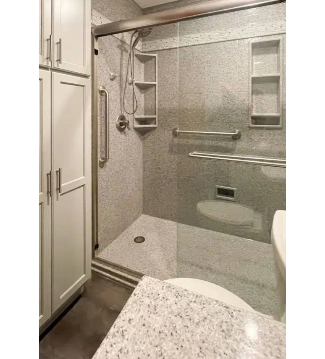 We finished this accessible walk-in shower with a glass door and grab bars.