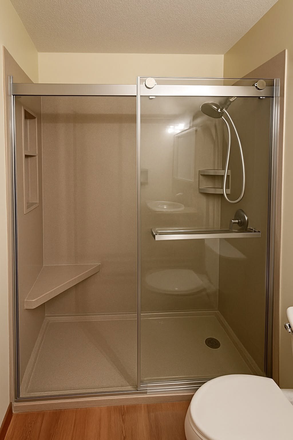 Tan solid-surface surround with a double sliding door. No grout to scrub.