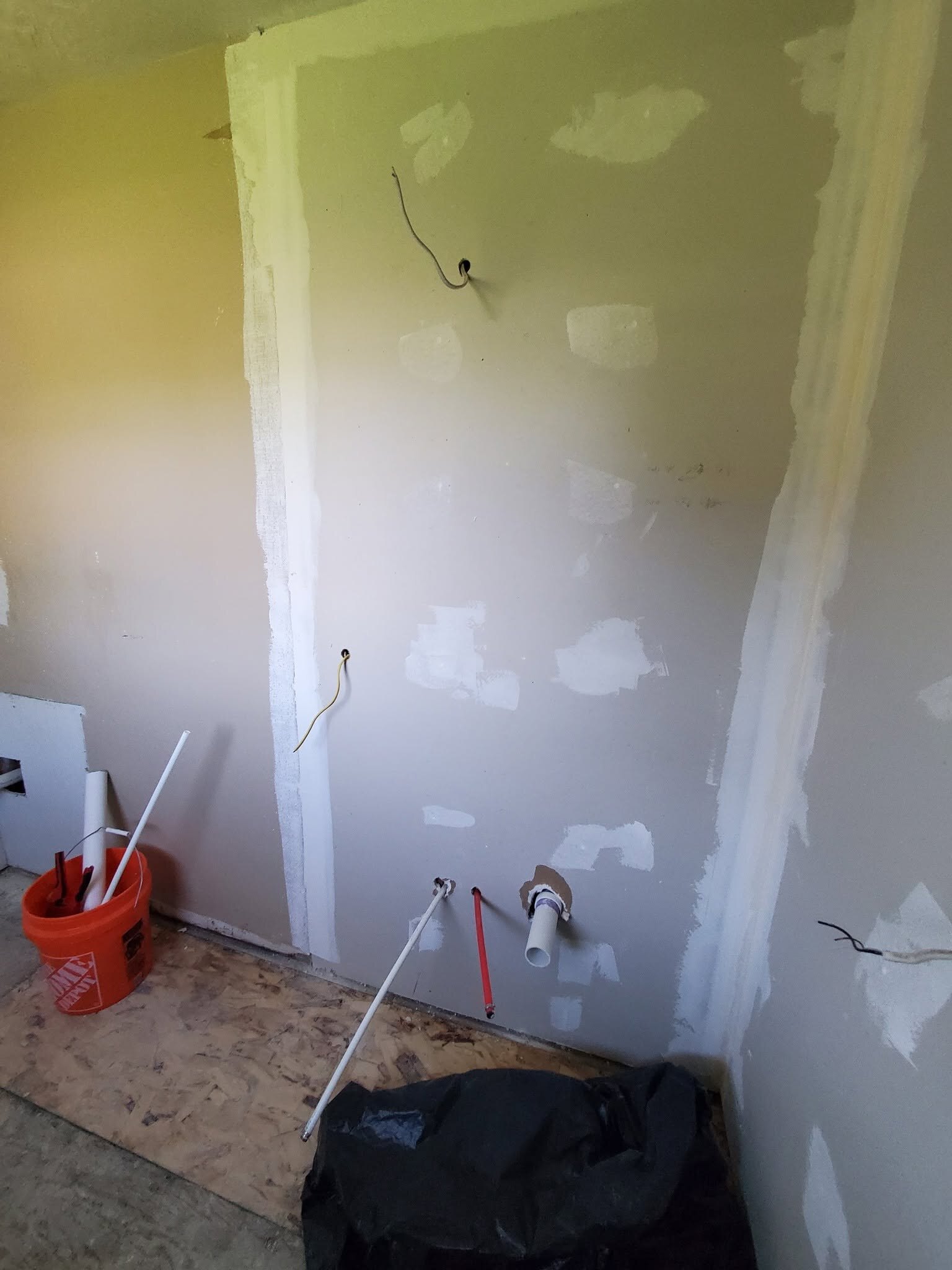 This bathroom is in the middle of drywall, with the PVC still rough-in.