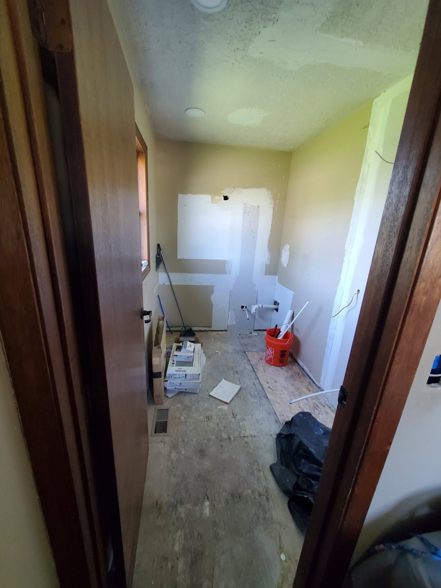 The room is still under construction, with the subfloor open.