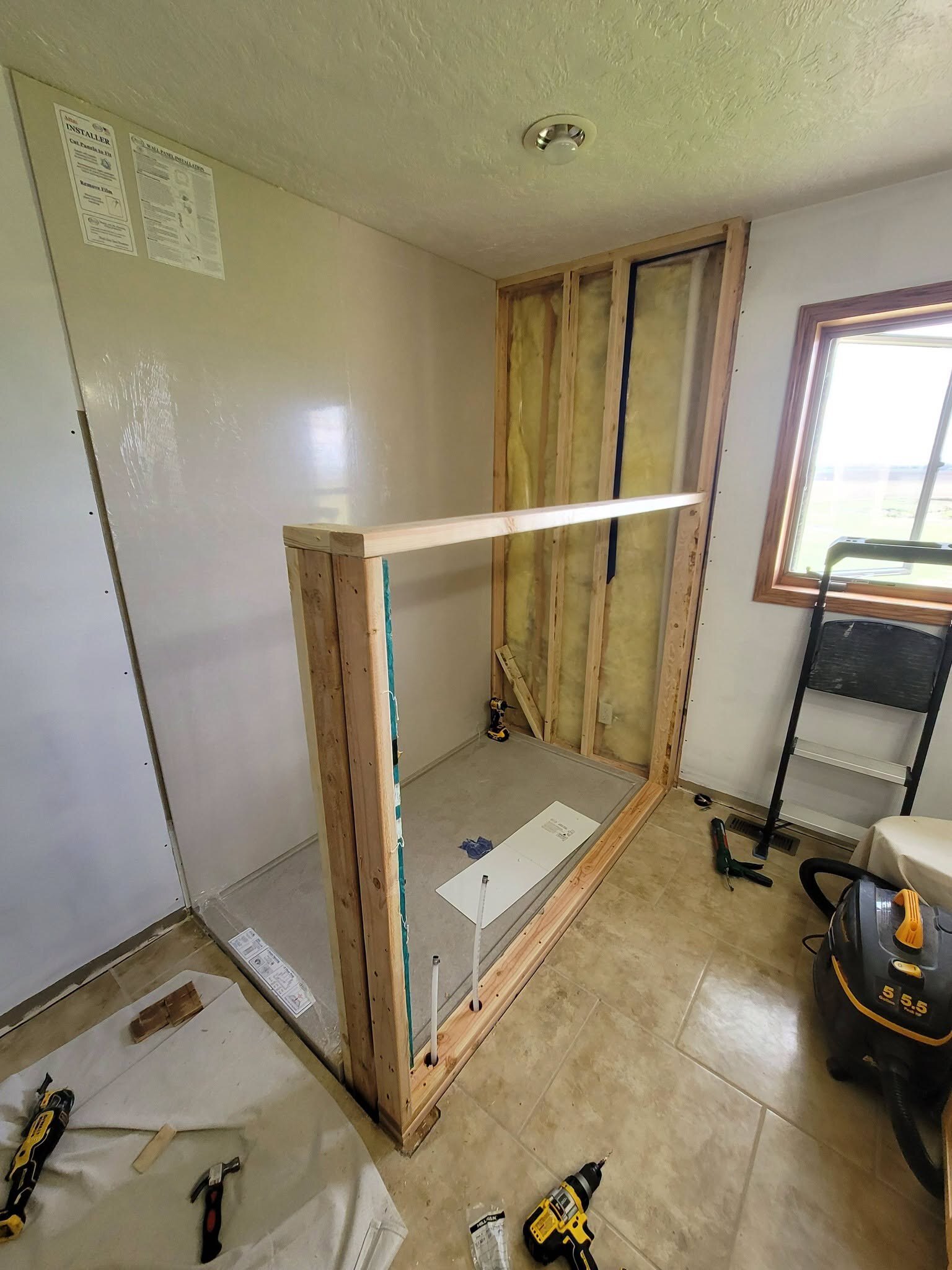 We framed the new shower stall and left the insulation open.