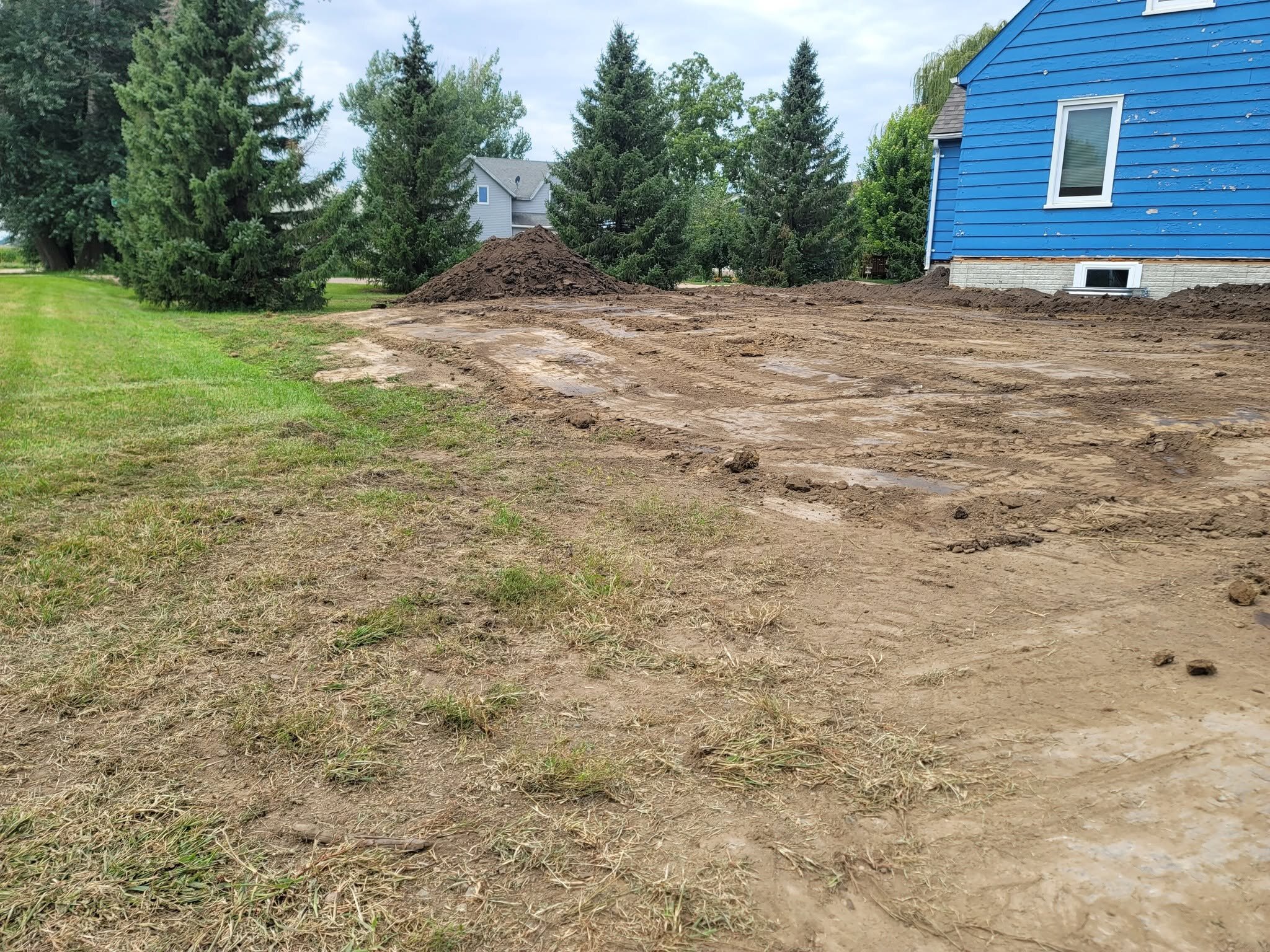 A back yard opened up. The dirt pile is the old grade coming out.
